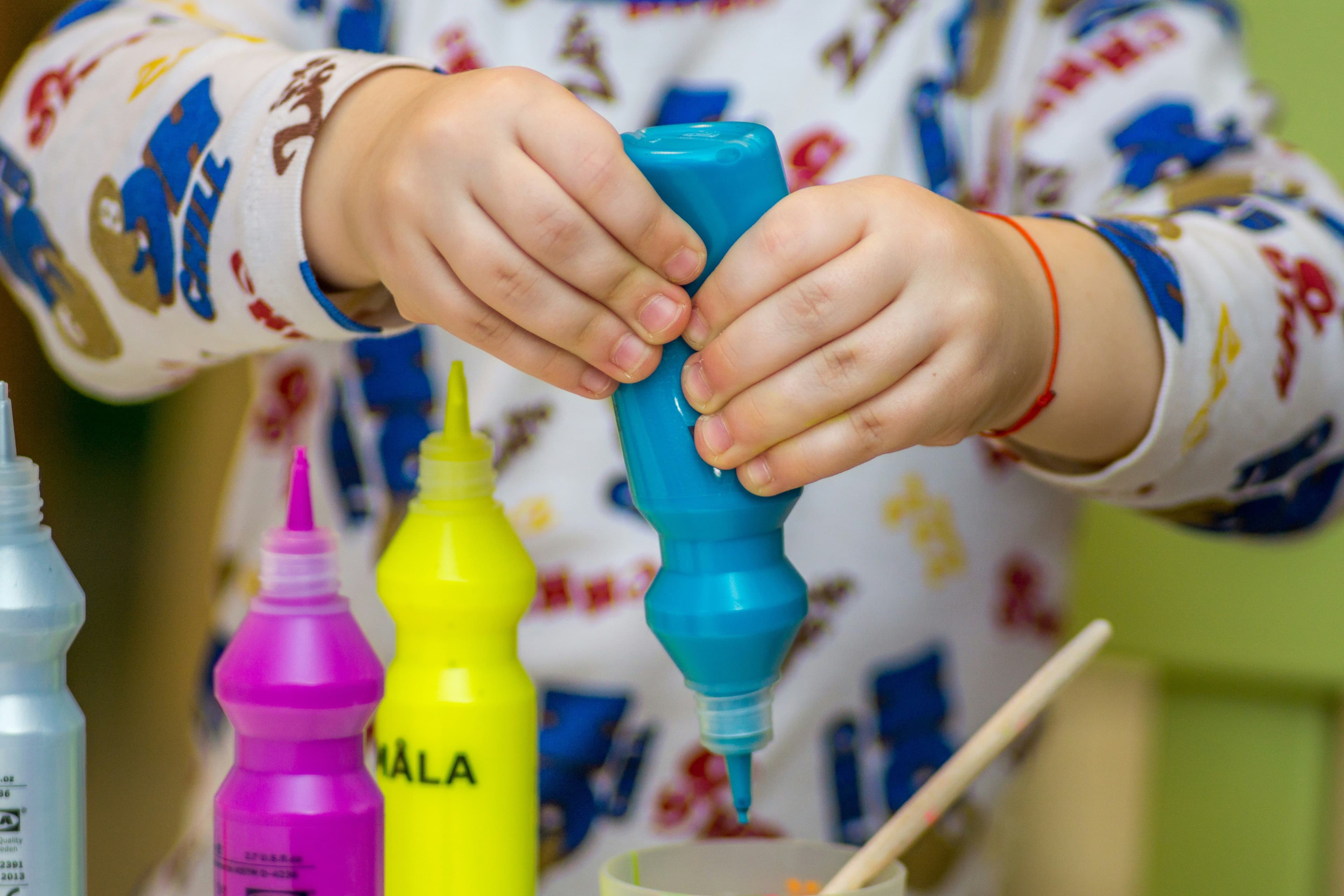 Image of a child with a paint bottle